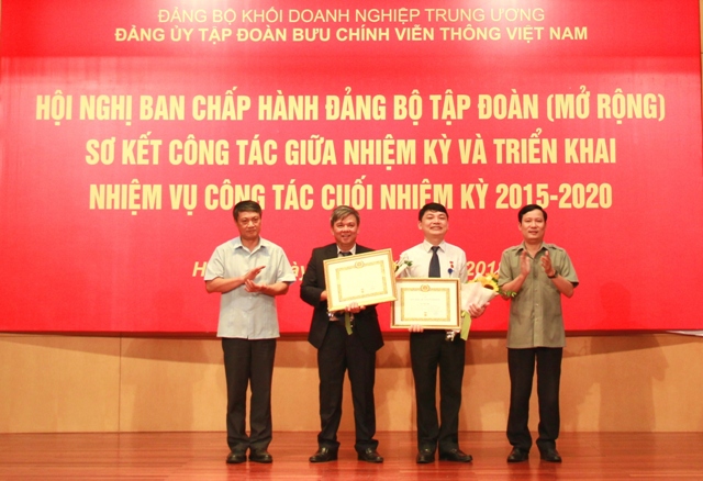 Đồng chí Phạm Tấn Công, Phó Bí thư Đảng ủy Khối DNTW và đồng chí Phạm Hồng Hải, Thứ trưởng Bộ Thông tin & Truyền thông trao Huy hiệu 30 năm tuổi Đảng cho 2 đảng viên của Đảng bộ Tập đoàn.