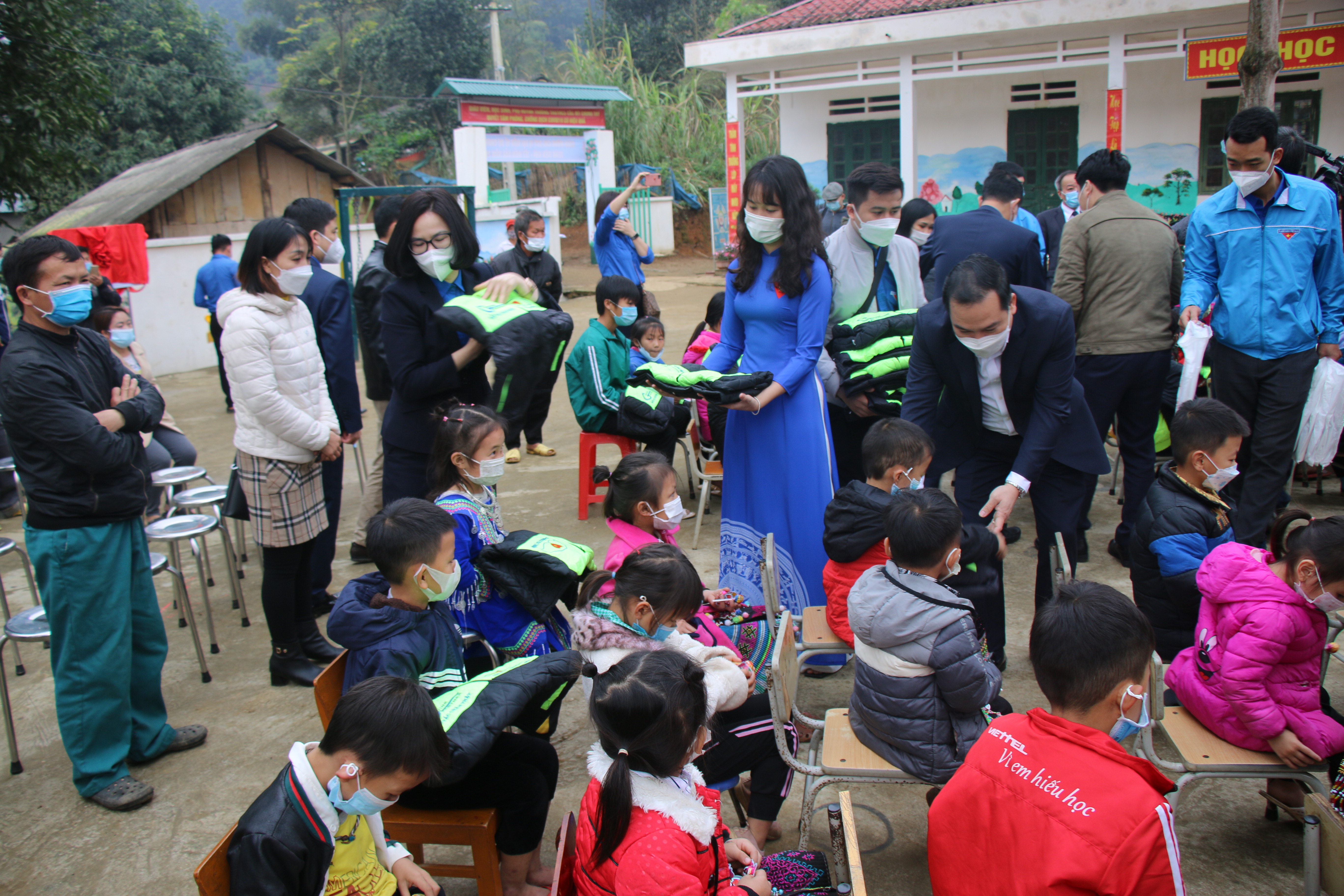 Đồng chí Hồ Xuân Trường, Phó Bí thư Đảng uỷ Khối và đồng chí Hoàng Thị Minh Thu, Uỷ viên BTV Trung ương Đoàn, Uỷ viên BCH Đảng bộ Khối, Bí thư Đoàn Khối DNTW trao tặng áo ấm cho các em học sinh.